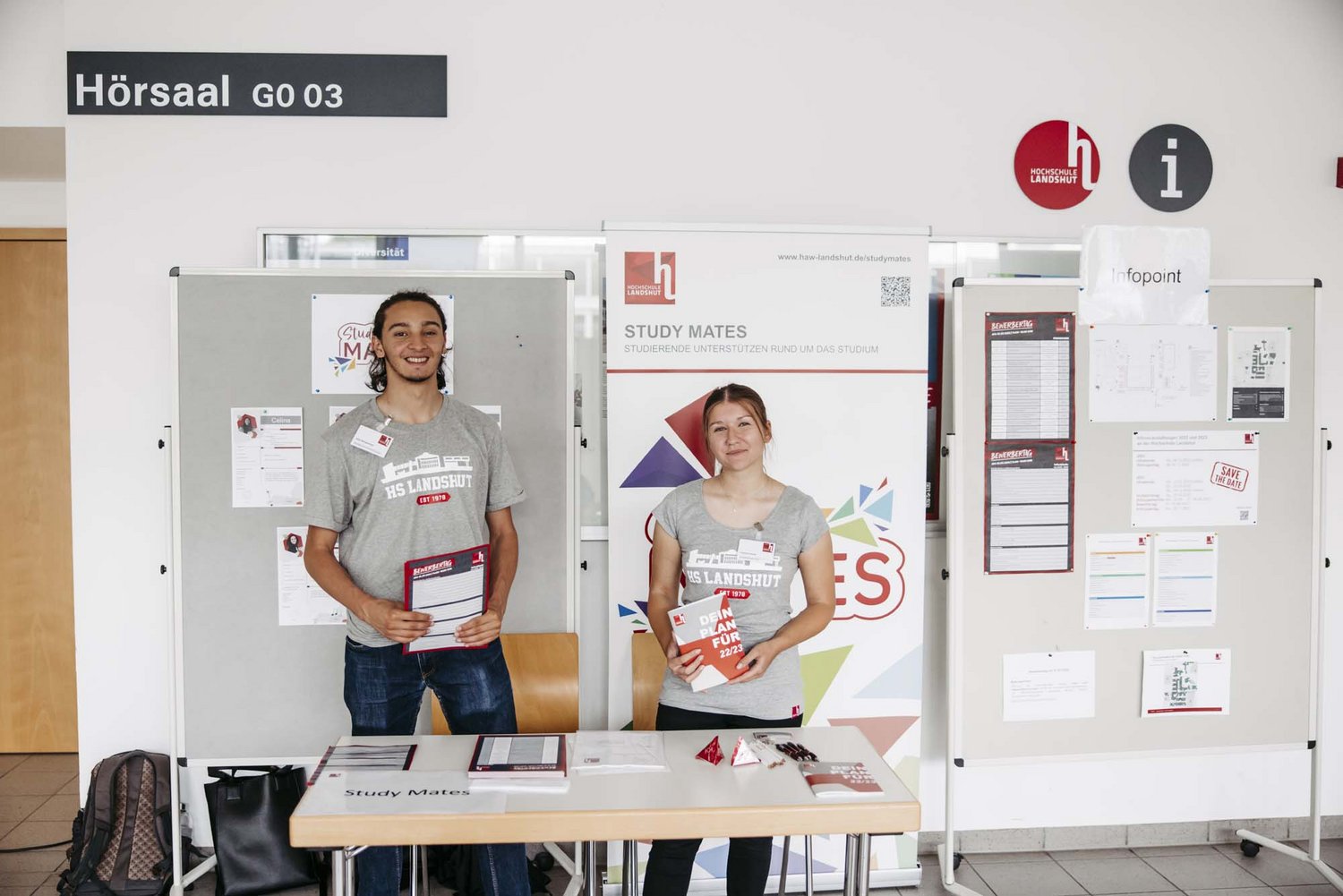 Mitglieder der Study Mates posieren vor Werbeaufstellern