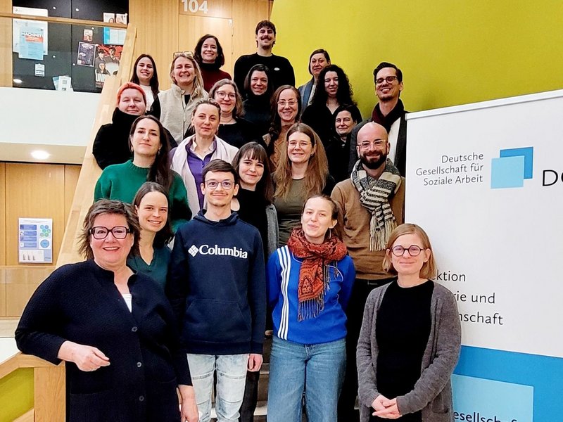 Gruppe von Leuten steht auf einer Treppe.
