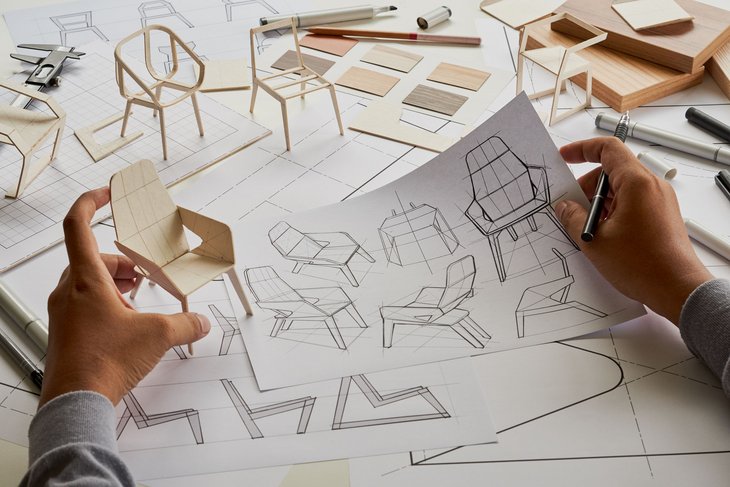Bild: Hände halten Skizze und Modell zur Entwicklung / Designstudie einer Stuhlkonstruktion